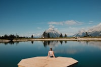 A peaceful moment by a crystal-clear alpine lake, surrounded by mountains and beautiful summer scenery.