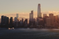 The San Francisco skyline at golden hour across the dark water of the bay