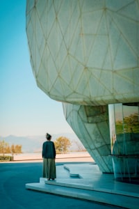 A woman outside the Bahá'í Temple in Santiago looking toward distant mountains